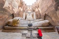 Red shirt woman paying respect to the largest Buddha image