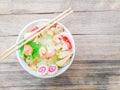 Sukiyaki or shabu soup with Dumplings, white cabbage, crab, vermicelli, shrimp, and chopsticks in a white cup Royalty Free Stock Photo