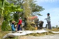 Farmers are grinding rice with a mobile rice milling machine. Royalty Free Stock Photo