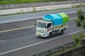 White Mitsubishi canter truck driving fast on the trans jawa highway toll road