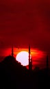 Suleymaniye Mosque and sun at sunset. Islamic or ramadan vertical photo.