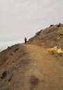 Sulfur miners walk at the top of Ijen crater.