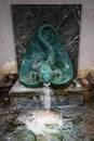 Sulfur spring flowing from a green lizard sculpture, Baldone, Latvia