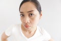 Sulk and grumpy face expression of woman in white t-shirt. Concept of offended peevish and sulky Royalty Free Stock Photo