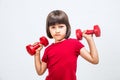 Sulking mad child frowning lifting dumbbells for girl-boy attitude Royalty Free Stock Photo