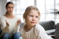 Sulky angry offended kid girl pouting ignoring mother scolding h Royalty Free Stock Photo