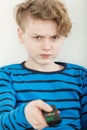 Sulky petulant young boy watching television Royalty Free Stock Photo