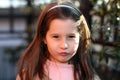 Sulky young girl outdoors in park Royalty Free Stock Photo