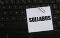 SULLABUS - word on a white sheet against the background of the laptop keyboard Royalty Free Stock Photo