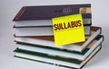 SULLABUS - word on a yellow piece of paper against the background of textbooks Royalty Free Stock Photo