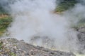 Sulphurous mountain valley with hot spring stream and steam at Tamagawa Onsen Hot spring in Senboku city, Akita prefecture, Tohoku