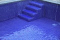 sulphurous, Swimming pool steps with clear water surface background, nobody. Abstract pool texture, underwater pattern blue Royalty Free Stock Photo