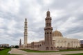 Sultan Qaboos Grand Mosque in Muscat, Oman, landscape view, with majestic marble walls and minaret.