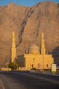 Sultan Qaboos Mosque in Bukha, Musandam, Oman at sunset with the beautiful mountains and blue sky in background Royalty Free Stock Photo