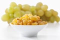 Sultana raisins and grapes on white background