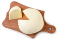 Suluguni cheese round on a kitchen board on a white background, isolated. Top view Royalty Free Stock Photo