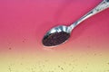 Sumac spice powder with macro lens photographed against colorful gradient in studio