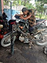 SUMATRA UTARA, INDONESIA - MAY 16 2020: Workers in vehicle service shops working on motorcycles. in the middle of the covid-19 Royalty Free Stock Photo