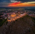 Sumeg, Hungary - Aerial view of the famous illuminated High Castle of Sumeg in Veszprem county at sunset with colorful clouds Royalty Free Stock Photo