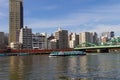 A futuristic looking boat passes by the Umayabashi Bridge on the Sumida river in Tokyo