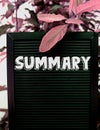 Summary concept - Isolated text on black background with colorful leaves