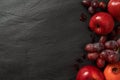 fruits background red color composition on dark stone slake plate. Summer abstract creative trendy fresh health concept. Flat lay