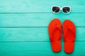 Flip flops, sunglasses. Summer accessories and copy space on blue wooden background. Top view Royalty Free Stock Photo