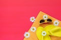 Summer accessories with chamomile flowers on pink floor Royalty Free Stock Photo