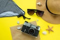 Vintage camera, hat, swimsuit, sunglasses on a yellow background. Summer concept. Flatlay, copyspase Royalty Free Stock Photo