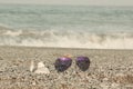 Summer Accessories Sunglasses in seaside beach- Summer concept. Royalty Free Stock Photo