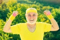 Summer and active holidays. Portrait of senior man holding dumbbell. Happy Senior sportman exercising with lifting Royalty Free Stock Photo