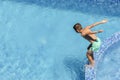 Summer active water fun on vacation. Boy child jumping into the pool Royalty Free Stock Photo