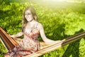 Summer Activity. Portrait of Winsome Relaxing Happy Smiling Blond Female Resting in Hummock in Spring Forest Outdoors