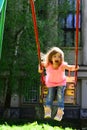 Summer activity. Small kid playing in summer. Happy laughing child girl on swing. childhood daydream .teen freedom Royalty Free Stock Photo