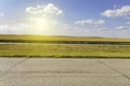Summer adventure road with old asphalt, gold rye field, blue cloudy sky Royalty Free Stock Photo