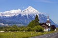 Summer alpine landscape Switzerland with snow peaks and wooden buildings Royalty Free Stock Photo