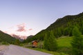 Summer in the Alps. Blooming alpine meadow and lush green woodland set amid high altitude mountain range. Royalty Free Stock Photo