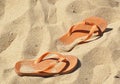 Orange Flip Flops in fine sand on the beach Royalty Free Stock Photo