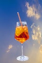 Summer aperitif drink with ice and straw on outdoor table