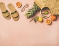 Summer apparel items and fresh fruits over pastel pink background