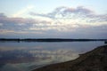 Summer of August. Warm evening on the shore of a forest lake. Reflection of trees in the mirror of the water green world Royalty Free Stock Photo