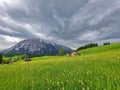 Summer austrian landscape with Grimming mountain 2.351 m, an isolated peak in the Dachstein Mountains, view from small alpine Royalty Free Stock Photo