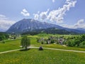 Summer austrian landscape with Grimming mountain 2.351 m, an isolated peak in the Dachstein Mountains, view from small alpine Royalty Free Stock Photo