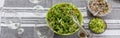 A picnic table with a large bowl of tossed garden salad and plates