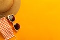 Summer background with beach accessories - straw hat, sunglasses, mask to prevent covid-19 on vibrant orange background Royalty Free Stock Photo