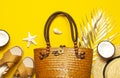 Summer background. Beach accessories. Beach wicker straw rattan women`s eco bag sandals straw hat coconut golden tropical leaf Royalty Free Stock Photo