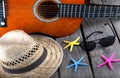 Summer background beach bar Acoustic guitar star hat and starfish on a wood Royalty Free Stock Photo