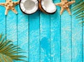 Summer background with beach sand, starfish coconut leaves, and shell decoration hanging on wooden background Royalty Free Stock Photo