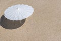 Summer background. Beach umbrella on sand of sea shore. Summer vacation, dream holiday, wellness concept, copy space Royalty Free Stock Photo