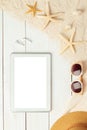 Summer background with blank screen tablet computer and beach accessories - sunglasses on white wood table background Royalty Free Stock Photo